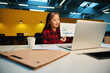 © Svitlana - Young asian businesswoman showing business graph during video call on laptop