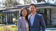© Keitma - Confident Asian american male and asian female couple buyers stands proudly outside the new house they just bought , radiating happiness and approachability, ready to move in their new acquired home