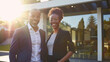 © Keitma - Confident black afro american male and african female couple buyers stands proudly outside the new house just bought, radiating happiness and approachability, ready to move in their new acquired home