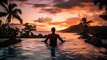 Couple On The Beach At Sunset. Young Man In An Infinity Pool During Sunset, Sunset Time At Sea. Vacation. Exotic. Ocean. Beautiful Picture