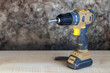 Electric Cordless Brushless Screwdriver for Construction Work on Wooden Table