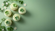 Top view of St. Patrick's Day cupcakes decorated with white frosting and shamrock sprinkles