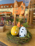 Fototapeta Tulipany - window of a toy shop decorated with for easter with colorful eggs