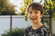 © Cavan Images - Portrait of a smiling boy on the street on a summer’s day
