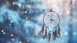 Dreamcatcher against a white blur of snow, A dream catcher hanging from a tree in the snow,Beautiful dream catcher on nature background,Close up of Dream Catcher on meadow background 
