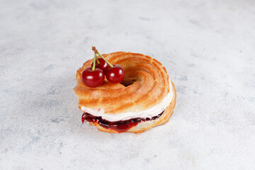 Wall Mural - Cream puffs with whipped cream and sour cherries.