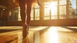 Graceful ballerina practicing dance moves in a sunlit dance studio.