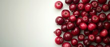  A Mountain Of Crimson Cranberries Stacked On Top Of One Another Atop A Pristine White Table Beside A Spotless White Wall