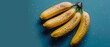   A group of ripe bananas resting on a blue surface with water droplets beneath