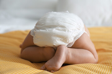 Wall Mural - Cute little baby in diaper on yellow blanket