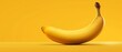   Ripe banana on yellow table beside peel