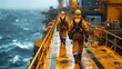 Oil Rig Workers on Stormy Sea Walkway. Oil workers in protective overalls walking on a narrow walkway above the turbulent ocean at an offshore drilling platform.