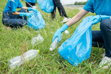 Happy volunteer people group charity with garbage bags cleaning up in park. Corporate social responsibility and society activity for Environment . Ecology and CSR concept.