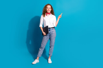 Poster - Photo portrait of pretty young woman point empty space netbook dressed stylish white clothes isolated on blue color background