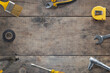 Top view flat lay of tools composition on a wooden table. Copy space in the middle. Ideal for DIY concept promotion