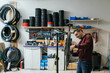 workshop scene where a mechanic is replacing the chain on a mountain bike