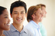 Asian man, diversity and coworker in row with smile for teamwork or collaboration and coworking as consultant. Portrait, colleagues and people as employees with confidence for business and growth