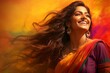A beautiful Indian woman is smiling, her long hair blowing in the wind, wearing traditional attire for the Holi festival.