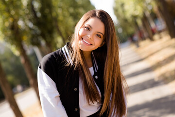 Sticker - Photo of toothy beaming friendly student with straight hairstyle dressed stylish jacket walking after exam in sunny weather outdoors