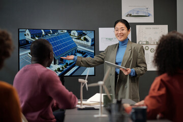 Aufkleber - Happy young Asian businesswoman with tablet pointing at interactive board during presentation of her project to colleagues