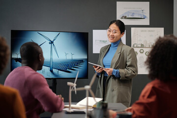 Aufkleber - Happy young woman in formalwear and eyeglasses standing by interactive board with windmill on screen during presentation of new project