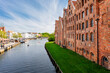 Scenic view panorama Lubeck hanseatic city blue sky sunny summer day. Travemünde Trave river embankment in Lübeck historic Holstentor museum Salzspeicher building in medieval town altstadt Germany