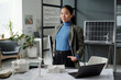Young confident Asian businesswoman in formalwear looking at camera during work over new architectural project in openspace office