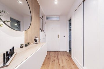 Sticker - Hallway of a beautiful modern home with a hanging sideboard and a circular mirror