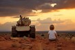 A little boy looks at the invading tank at sunset. A symbol of peace and war.