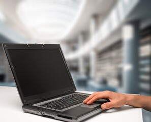 Wall Mural - businessman hand on laptop computer in office