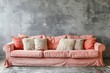 Modern interior featuring a peach velvet sofa with a mix of textured and smooth pillows, set against an abstractly painted wall