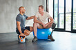© peopleimages.com - Workout, gym ball and man with a disability and physio consultation for rehabilitation. Physiotherapy, help and healthcare professional with kettlebell and wellness for mobility exercise and sport