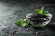 A luxurious glass bowl of black caviar garnished with fresh herbs
