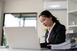 © Natee Meepian - Asian woman accounting sit at their desks and calculate financial graph showing results about their investment, planning successful business growth process