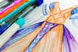 closeup of a dress sketch with a vibrant marker collection aside