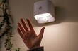 closeup of a hand waving in front of a motion sensor light