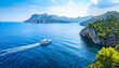 Panoramic view of a luxury yacht confidently sailing in the sparkling Mediterranean Sea - symbolizing wealth and the joys of affluent living wide