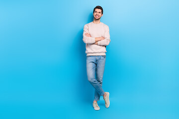 Wall Mural - Full length photo of confident dreamy man wear beige sweatshirt arms folded looking empty space isolated blue color background