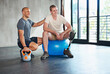© peopleimages.com - Personal trainer, man with disability or leg in fitness, exercise or strength training for health. Male physio, kettlebell or prosthesis to relax in support, motivation or professional physiotherapy