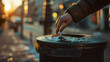 A persons hand discarding a pack of cigarettes into a trash can a decision for health.