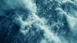 Aerial view of dynamic ocean waves with foam and ripples, capturing the power and texture of the sea in shades of blue and turquoise.