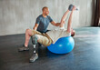 © peopleimages.com - Physiotherapist, patient with disability or kettlebell or exercise ball at gym for recovery, people and healthcare rehabilitation. Physiotherapy, consultation and support or workout for amputee