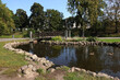 Decorative pond and small bridge with many padlocks in the City park Bastion Hill in Riga center on sunny day