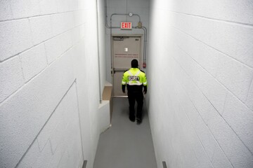 A security guard is patrolling an office at night.