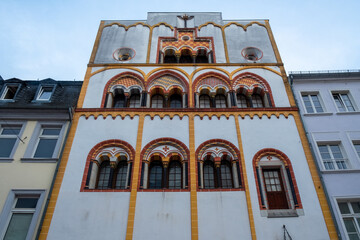 Trier, Rijnland-Palts, Germany, 23th of March, 2024, This vertical shot captures the striking Romanesque Revival architecture in Trier, Germany. It features the building's vivid white, yellow, and red