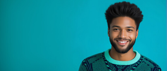 Portrait of a cheerful young African American man with a modern hairstyle, wearing a sweater against a turquoise background, suitable for fashion and lifestyle concepts