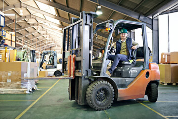 Wall Mural - Driver, warehouse and man with forklift on site working, loading on dock with Industrial moving vehicle. Transporting, shipping inventory with safety hardhat for delivery, labor worker for company