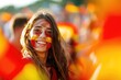 Spanish soccer fan woman with national flag of spanish painted on her face.. Celebrating crowd in a stadium. Cheering during a match in stadium