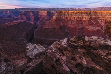 Poster - the grand canyon is illuminated by colorful light from the sunset