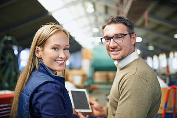 Canvas Print - Business people, industry and portrait in warehouse with tablet for collaboration, ecommerce and distribution. Woman, man and smile with digital technology for supply chain, teamwork and inspection